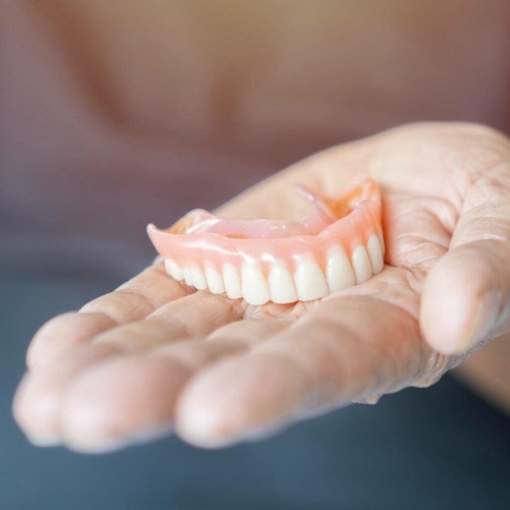 Woman smiling with partial dentures, Hackettstown NJ Dentist